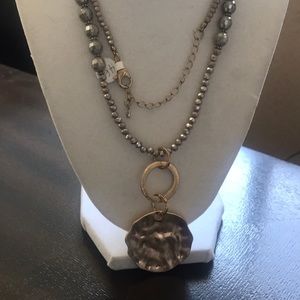 Crystal necklace with gold desk.